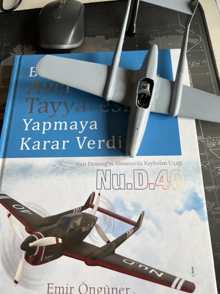 Unpainted Fokker D.XXIII model resting on the book about the Nu.D.40.