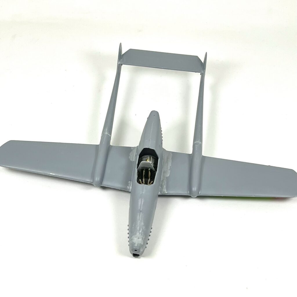 Unpainted 1/48 twin-boom aircraft with filled assembly joins.