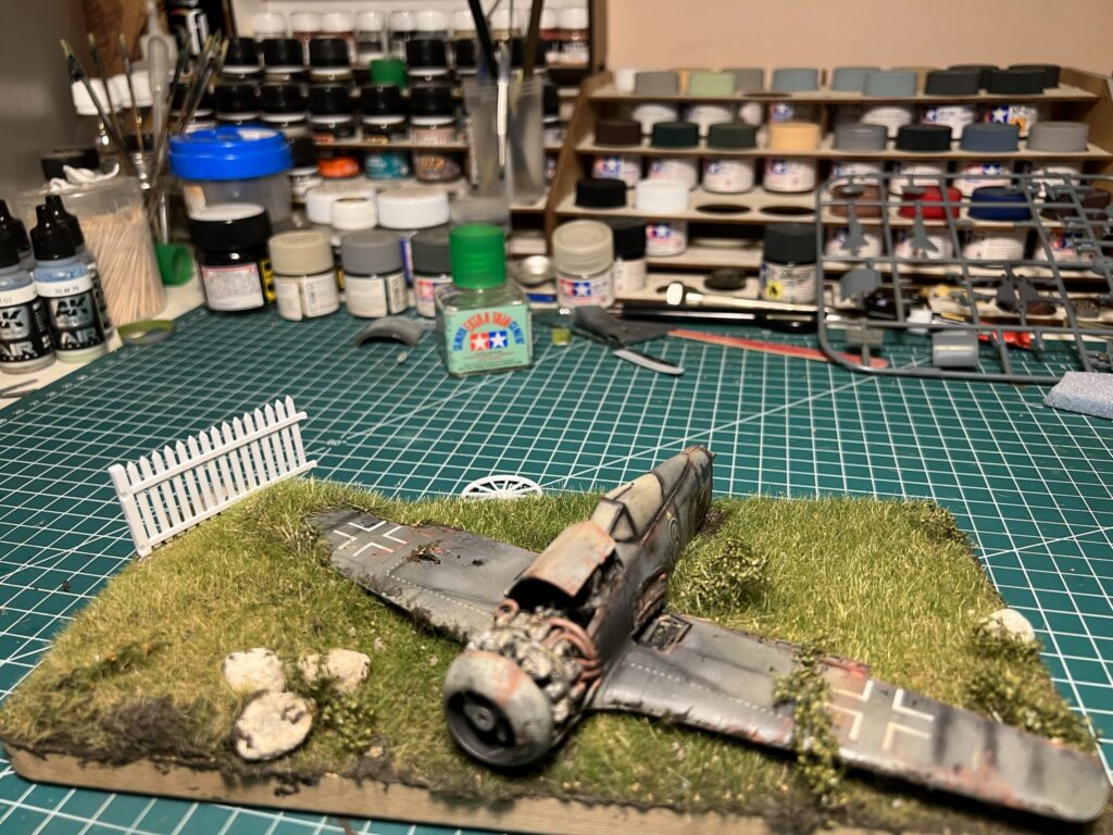 The diorama base with grass and fence