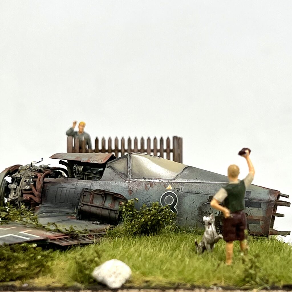 The scene with the fence and figures