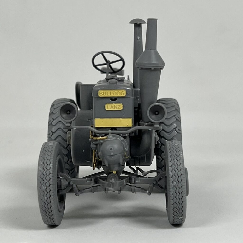 Front view of the Lanz Bulldog in grey primer with the Bulldog and Lanz nameplates
