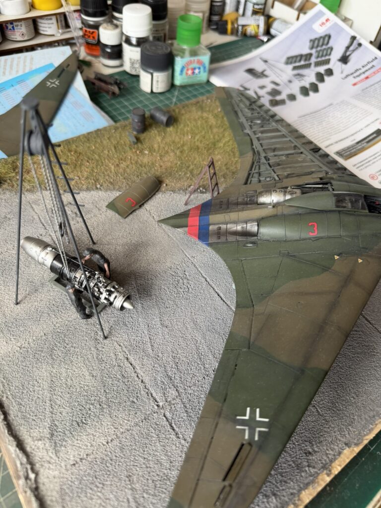 Engine on the hoist beside the open wing