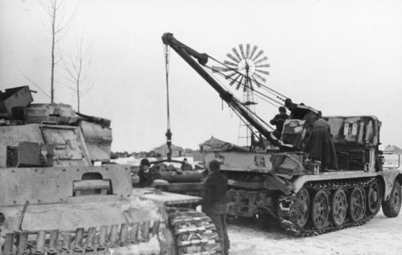An Sd.Kfz. 9/1 crane half-track during the repair of a Panzer III in Russia