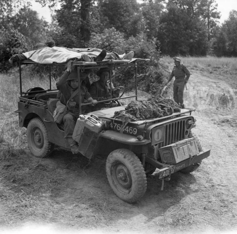 A jeep modified to carry two stretchers bringing casualties back to an aid post, Normandy, July 1944